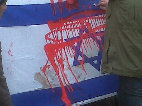 Supporters spattered an Israeli flag with fake blood.