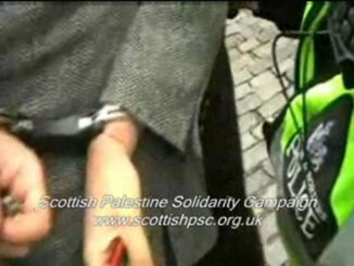 Napier is led away after being assaulted and handcuffed